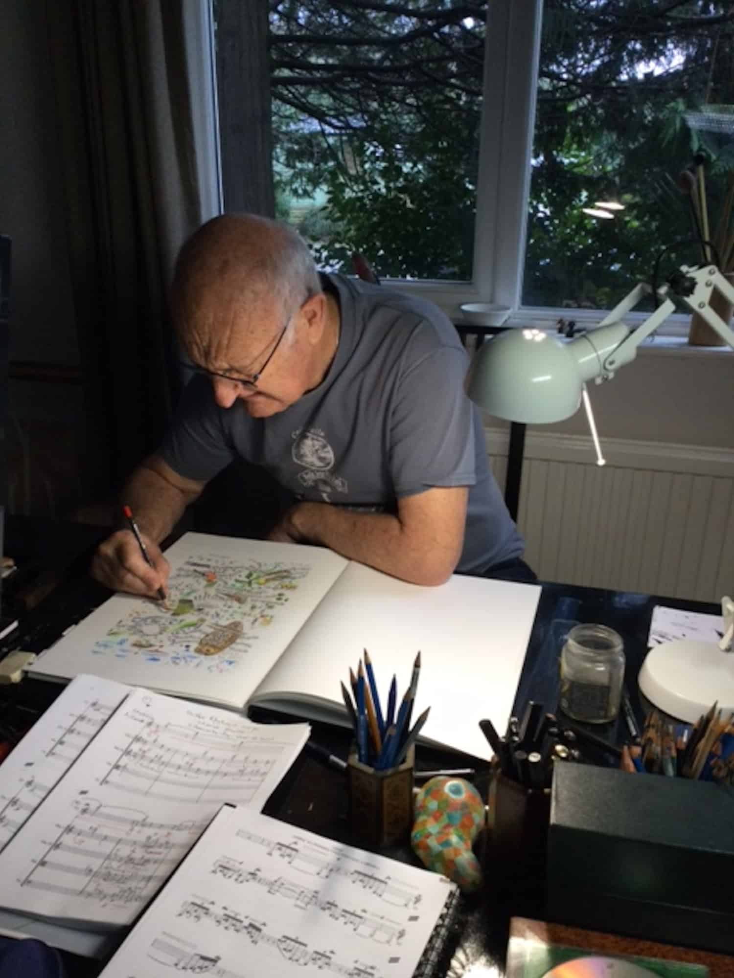 Edward Cowie working on score and study drawing for Bird Portraits